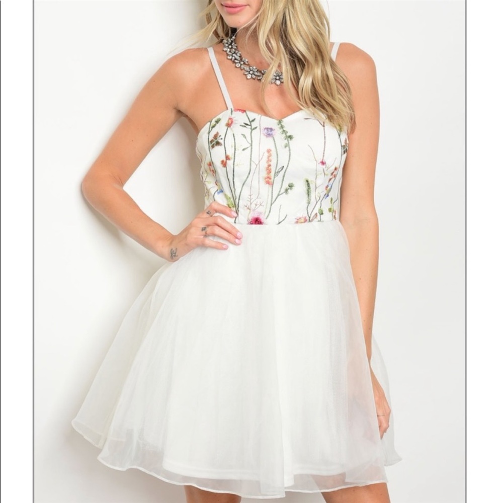 White dress that poofs out at the bottom with a floral spaghetti strap top